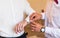 Groomsman helps groom to put on cufflinks close-up