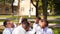 Groomsmen toss groom in the air. Man flexing and having fun with best friends on wedding day in park. Cheerful guys