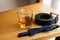 Groomâ€™s accessories: blue necktie and glass of whiskey, black leather belt,