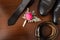 Groomâ€™s accessories: flower boutonniere in focus, leather belt, necktie, shoes.