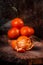 Groop of mandarin tangerine, one pilled over on old rustic background. Snow effect. Christmas and New year mood