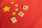 Gross Domestic Product or GDP of China on Wooden block letters on Chinese flag