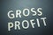 Gross profit written with wooden letters on a green background