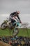 Gross Schwiesow, Germany - March 01,2019 - Motocross racer making a stunt and jumps in the air over a sand hill