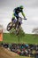 Gross Schwiesow, Germany - March 01,2019 - Motocross racer making a stunt and jumps in the air over a sand hill