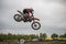 Gross Schwiesow, Germany - March 01,2019 - Motocross racer making a stunt and jumps in the air over a sand hill