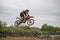 Gross Schwiesow, Germany - March 01,2019 - Motocross racer making a stunt and jumps in the air over a sand hill