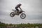 Gross Schwiesow, Germany - March 01,2019 - Motocross racer making a stunt and jumps in the air over a sand hill