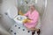 Grossed out senior woman cleaning the toilet