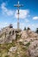 Grosser Rachel hill in Bavarian Forest mountains with hikers, cross and rocks