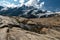 Grossglockner mountain lake rocks and yellow flowers in the foreground in the Austrian Alps in the Hohe Tauern mountains