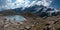 Grossglockner mountain lake rocks and yellow flowers in the foreground in the Austrian Alps in the Hohe Tauern mountains