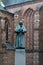 Grote Kerk ans bronze statue in the old city of Naarden at sunset