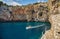 Grotta Zinzulusa. View from the cliff to the crystal clear azure Adriatic Sea with transparent water. gangway under the rocks to