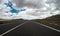 Ground beautiful view of long way straight asphalt road and blue clouds sky in background - concept of drive and travel with