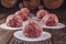 Ground beef balls for hamburger with wood pile background