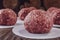 Ground beef balls for hamburger with wood pile background - Close-up