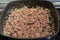 Ground beef browning in pot with onions