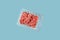 Ground beef or cultured artificial meat isolated on laboratory blue background