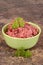 Ground beef in a green bowl