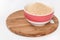 Ground biscuits for preparing cake in white bowl on wooden board