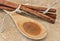 Ground cinnamon on wooden spoon macro