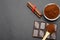 Ground coffee and chocolate on the black background and fresh piled coffee on wooden spoon