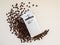Ground coffee Lavazza Crema E Gusto in a silver pack and coffee beans on a white table. Coffee in a circular economical packaging.