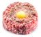 Ground cutlet or raw hamburger with quail egg yolk and seasonings on white background. Top view