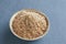 Ground flaxseed in a bowl on a slate background, selective focus