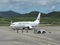 Ground handling staff and mechanic waving to departing airplane at Ishigaki airport, Okinawa, Japa