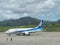 Ground handling staff and mechanic waving to departing airplane at Ishigaki airport, Okinawa, Japa