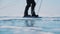 Ground level shot focused on skates of traveller riding on flat ice covered surface of lake. Member of expedition moving