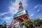 Ground level side view of Sapporo TV Tower from Odori Park with blurred cloud streaks