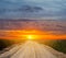 Ground road among a prairie at the  sunset