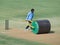 Ground`s men Levelling cricket pitch.