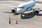 Ground staff airplane marshaller meets passenger plane after landing flight