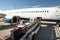 ground staff handling an aircraft before departure at the airport - loading luggage