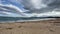 Ground view beach sand on sea waves with clouds