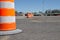 Ground view orange and white pylons lined up in a parking lot