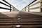 Ground view over an empty wooden pier with nails and a railing, central perspective with decreasing depth of field