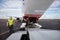 Ground Worker Standing By Aircraft With Communication Cable On R