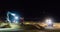 Ground workers working at night in a digger excavator and bulldozer moving the sand at the beach