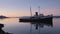 The grounded tug boat HMS Justice sits in Beagle Bay,Ushuaia at sunset