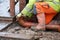 Groundworker fitting plastic drainage pipe to connect new build house to the underground drainage network