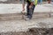 Groundworker making shutter for concrete to form a base for kerb using scaffold boards