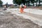 Groundworker making shutter for concrete to form base for kerb using scaffold boards and steel road pins during new road