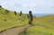 Group of abandoned massive Moai statues scattered on the slope of Rano Raraku volcano, historic Moai quarry on Easter Island