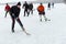 Group of active different aged people playing hokey on a frozen river Dnipro in Ukraine