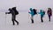 Group of active men and women with backpacks ans ski poles walking across frozen river in strong winter wind.